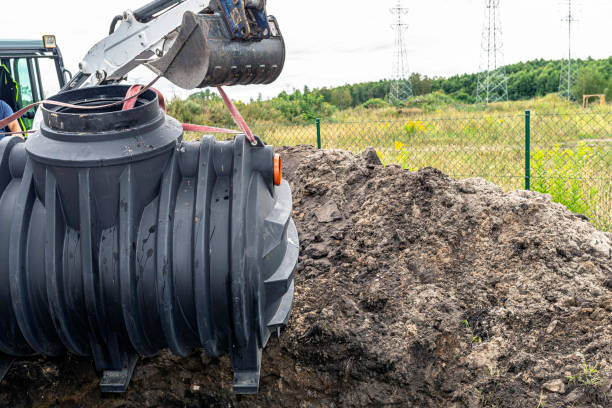 A professional inspecting a manhole.